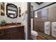 Bathroom featuring wood cabinets, a framed mirror and a walk-in glass shower at 4610 13Th W St, Palmetto, FL 34221