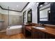 Luxurious bathroom with double vanity, modern fixtures, a glass-enclosed shower, and a relaxing soaking tub at 4610 13Th W St, Palmetto, FL 34221