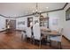 An open-concept dining room offers great flow, hardwood floors, neutral paint, and decorative lighting at 4610 13Th W St, Palmetto, FL 34221