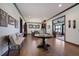 Hardwood floors accentuate this foyer with a view into the dining room. Bench seating for guests at 4610 13Th W St, Palmetto, FL 34221