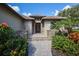 Home's entrance with stone accents, elegant decor, and lush landscaping enhancing curb appeal at 4610 13Th W St, Palmetto, FL 34221