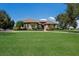 Beautifully landscaped home exterior with a sprawling lawn and inviting facade under a blue sky at 4610 13Th W St, Palmetto, FL 34221