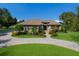 Stunning home with lush landscaping, circular driveway, and classic architecture on a sunny day at 4610 13Th W St, Palmetto, FL 34221