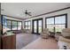 This sunny living room has brick flooring, large windows, neutral paint, and ample seating at 4610 13Th W St, Palmetto, FL 34221