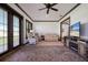 This bright and sunny living room features brick flooring, a ceiling fan, neutral paint, and ample seating at 4610 13Th W St, Palmetto, FL 34221