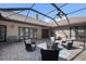 A beautiful screened-in patio features a ceiling fan, a fire pit and multiple seating options at 4610 13Th W St, Palmetto, FL 34221