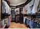 Spacious walk-in closet with custom built-in shelving and wooden floors for organized storage and easy access at 4610 13Th W St, Palmetto, FL 34221
