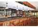 Upscale bar area with a granite countertop, wood accents, pendant lighting, and comfortable seating at 4832 Carrington Cir, Sarasota, FL 34243