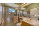 Well-lit bathroom featuring a glass shower door and neutral tile at 4832 Carrington Cir, Sarasota, FL 34243