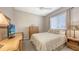 Cozy bedroom featuring neutral paint, carpet floors, stylish furniture, ceiling fan and bright window at 4832 Carrington Cir, Sarasota, FL 34243