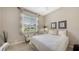 Bright bedroom with a large window and neutral decor at 4832 Carrington Cir, Sarasota, FL 34243