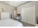 Neutral bedroom featuring a double door closet, white walls, and neutral carpeting at 4832 Carrington Cir, Sarasota, FL 34243