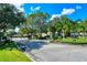 Gated entrance to the Treymore community, featuring meticulously maintained landscaping and mature trees at 4832 Carrington Cir, Sarasota, FL 34243