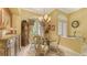 Charming dining area with elegant chandelier and double doors to the outside at 4832 Carrington Cir, Sarasota, FL 34243