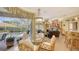 Open dining area with view to pool, ceiling fans, and adjacent living room at 4832 Carrington Cir, Sarasota, FL 34243