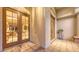 Inviting entryway with double doors leading to the home's interior and covered front porch at 4832 Carrington Cir, Sarasota, FL 34243