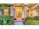 Elegant entryway featuring double doors, stately columns, and professionally landscaped at 4832 Carrington Cir, Sarasota, FL 34243