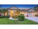 Charming one-story home featuring a well-manicured lawn, tropical landscaping, and a welcoming entrance with double doors at 4832 Carrington Cir, Sarasota, FL 34243