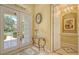 Bright foyer with tiled floors, glass table, and views of the elegant living spaces at 4832 Carrington Cir, Sarasota, FL 34243