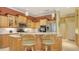 Well-equipped kitchen with wooden cabinets, stainless appliances, and breakfast bar at 4832 Carrington Cir, Sarasota, FL 34243