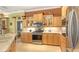 Well-lit kitchen featuring stainless appliances, wood cabinetry, and ample counter space at 4832 Carrington Cir, Sarasota, FL 34243