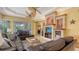 Bright living room with dual ceiling fans, comfortable seating, and stylish built-in shelving at 4832 Carrington Cir, Sarasota, FL 34243
