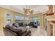 A spacious living room with dual ceiling fans, ample seating, and a view of the backyard at 4832 Carrington Cir, Sarasota, FL 34243