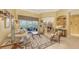 Spacious living room featuring neutral decor, tile flooring, and sliding glass doors at 4832 Carrington Cir, Sarasota, FL 34243