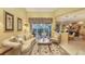 Bright living room featuring tile floors, neutral decor, and outdoor views at 4832 Carrington Cir, Sarasota, FL 34243