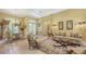 Elegant living room with tile floors, chandelier, and lots of natural light at 4832 Carrington Cir, Sarasota, FL 34243