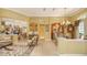Open living room with view to kitchen and dining areas, tile floors, and neutral decor at 4832 Carrington Cir, Sarasota, FL 34243