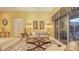 Elegant living room featuring neutral decor, tiled flooring, and sliding glass doors at 4832 Carrington Cir, Sarasota, FL 34243