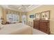 Bright main bedroom featuring neutral walls, plush carpeting, and a large window view of the pool area at 4832 Carrington Cir, Sarasota, FL 34243