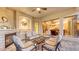 Cozy outdoor living space with fireplace and seating, offering a view inside the beautiful home at 4832 Carrington Cir, Sarasota, FL 34243