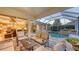 Inviting covered patio with comfortable seating and views of the pool, enhancing the outdoor living experience at 4832 Carrington Cir, Sarasota, FL 34243