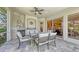 Beautiful outdoor patio with fireplace, comfortable seating, and sliding doors leading to the interior at 4832 Carrington Cir, Sarasota, FL 34243