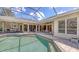 Screened-in pool area featuring a covered patio with outdoor seating at 4832 Carrington Cir, Sarasota, FL 34243