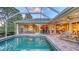 Beautiful pool with spa and screened enclosure, surrounded by lush landscaping and patio area at 4832 Carrington Cir, Sarasota, FL 34243