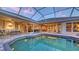 Screened-in pool and patio with outdoor seating and views into the house at 4832 Carrington Cir, Sarasota, FL 34243