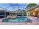 Beautiful backyard pool and spa featuring brick pavers and lush landscaping at 4832 Carrington Cir, Sarasota, FL 34243