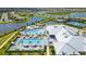 Aerial view of pools, umbrellas, and palm trees in a resort style community at 4951 Oyster Pearl St, Lakewood Ranch, FL 34211