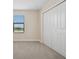 Bedroom with neutral carpet, a window, and a large double door closet at 4951 Oyster Pearl St, Lakewood Ranch, FL 34211