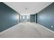 Large bonus room area with neutral carpet and teal painted walls at 4951 Oyster Pearl St, Lakewood Ranch, FL 34211