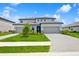 Beautiful two-story home with a three-car garage, well-maintained lawn, and decorative stone accents at 4951 Oyster Pearl St, Lakewood Ranch, FL 34211