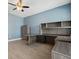 Home office with wooden desk, ceiling fan and plenty of storage space at 4951 Oyster Pearl St, Lakewood Ranch, FL 34211