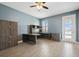 Home office with wooden desk, ceiling fan and plenty of storage space at 4951 Oyster Pearl St, Lakewood Ranch, FL 34211