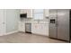 Modern kitchen with stainless steel appliances, white cabinets, and white counter tops at 4951 Oyster Pearl St, Lakewood Ranch, FL 34211