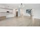 Spacious open-concept living area with modern kitchen and stylish staircase at 4951 Oyster Pearl St, Lakewood Ranch, FL 34211