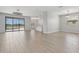 Open living space featuring wood floors, modern lighting, and sliding doors to the screened lanai at 4951 Oyster Pearl St, Lakewood Ranch, FL 34211