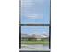 Window with a view of other houses and a small pond at 4951 Oyster Pearl St, Lakewood Ranch, FL 34211